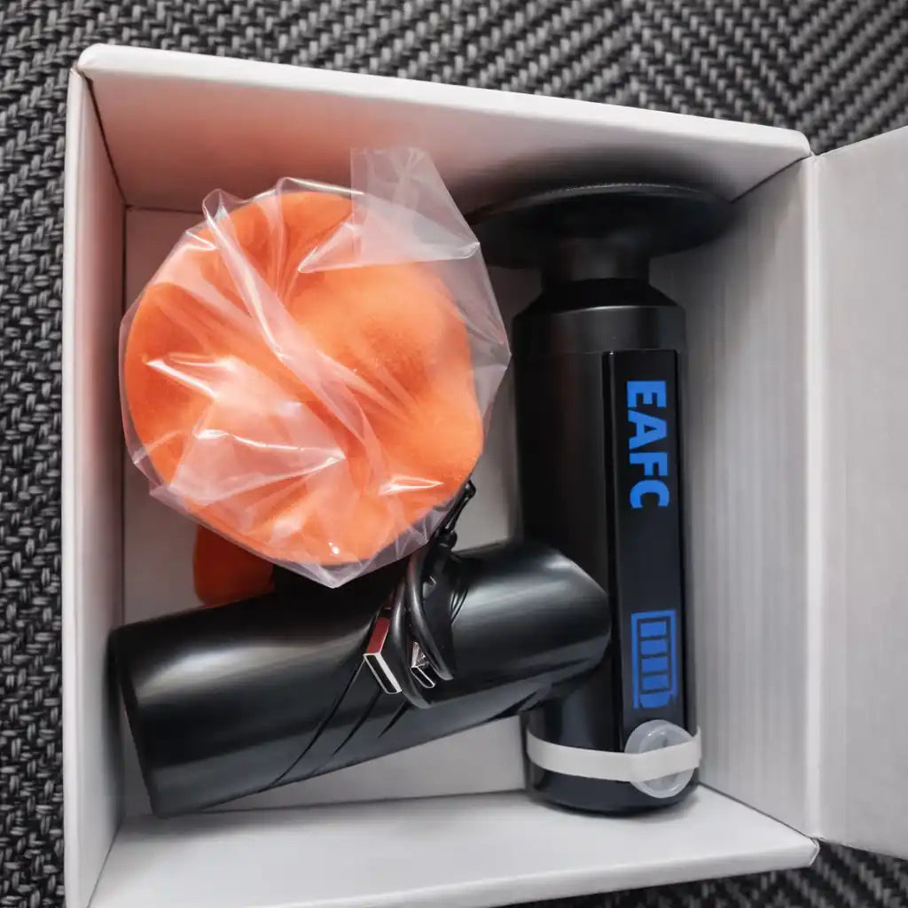 Black handheld device with 'EAFC' branding in a box with an orange cover.