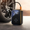 Portable car tire inflator with digital display next to a car tire.