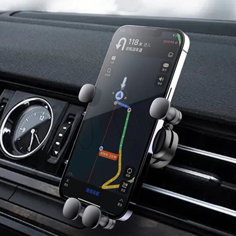 Phone mounted on a car holder with navigation app displayed, inside a vehicle.