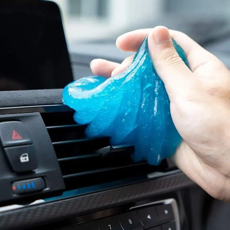 Blue gel putty removing dust from car air vents