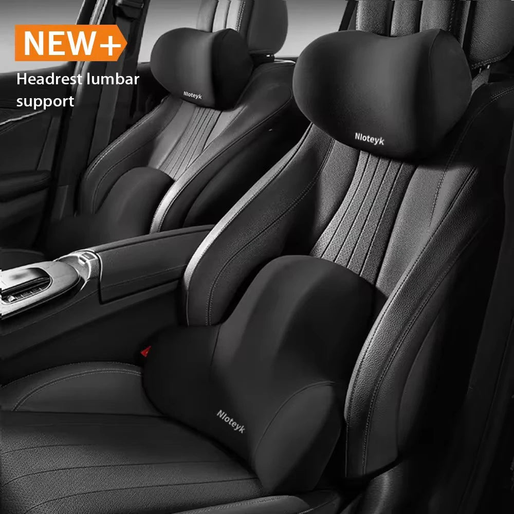 Car interior with headrest lumbar support pillows.